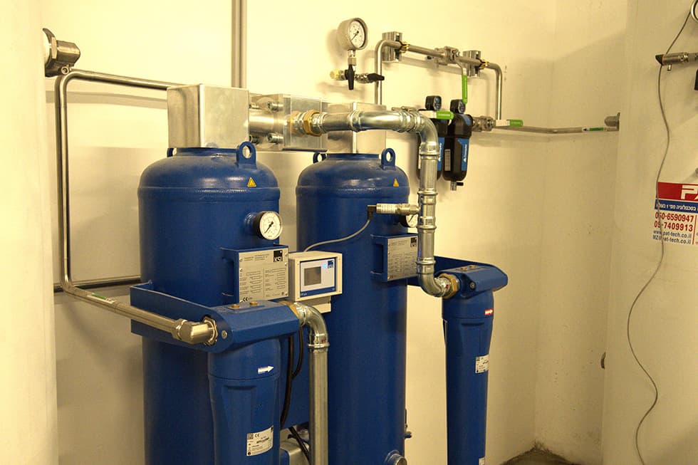 An air dryer and filters in the corner of a plant room