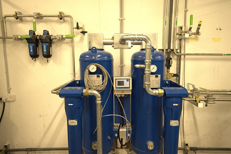 A twin-tower air dryer with a controller and two wall-mounted filters