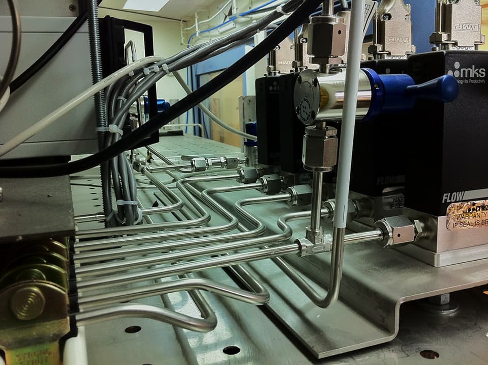 Instrument bench with stainless tubing runs and a measuring device