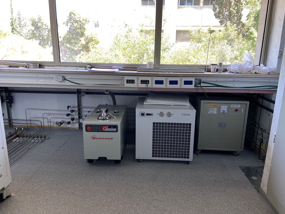 Laboratory bench with chillers and gas lines along the window