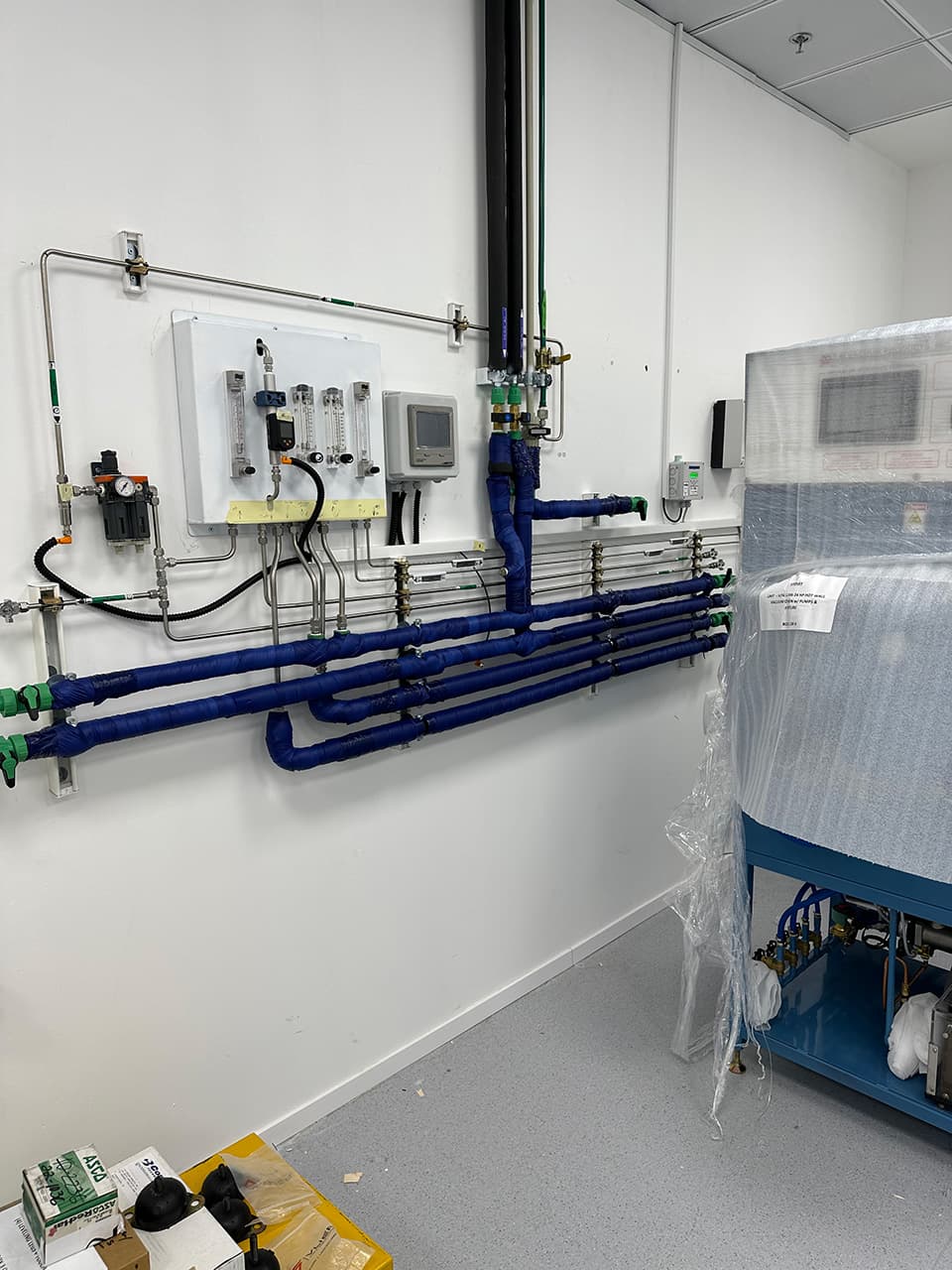 Clean-room wall with a panel and blue lines