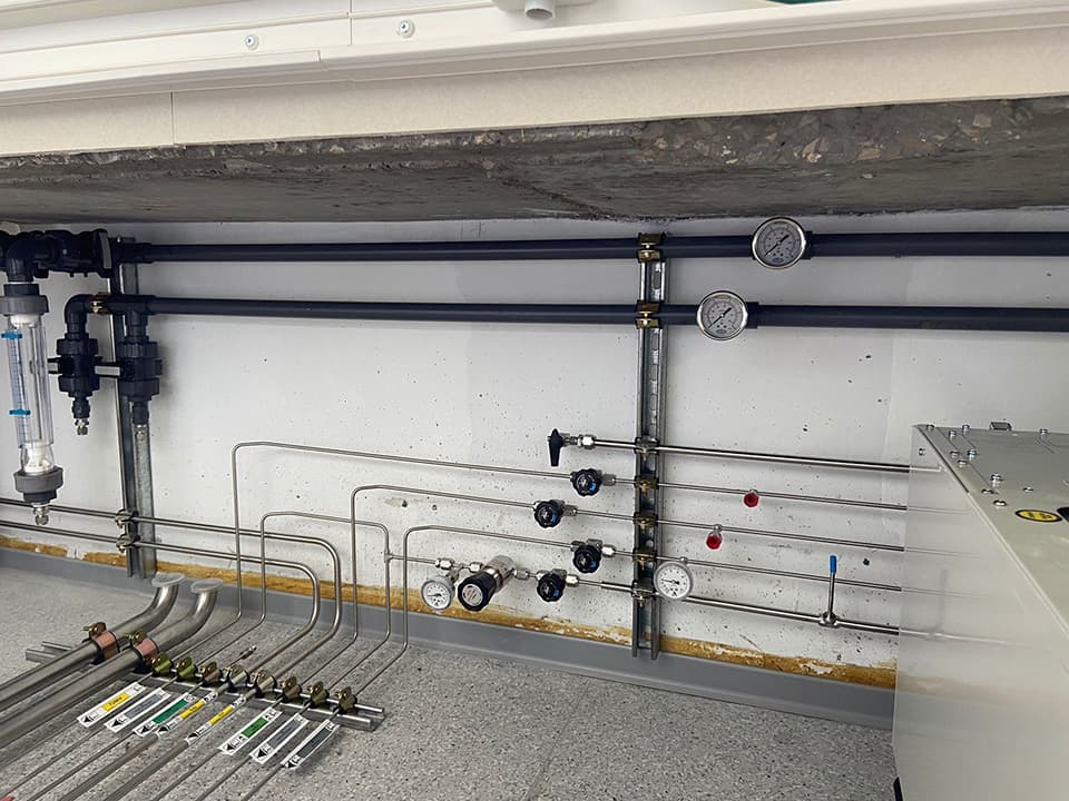 Bench with pipe runs and colour-coded valves