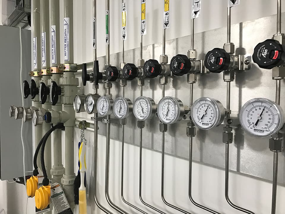 Close-up of a regulator bank with pressure gauges