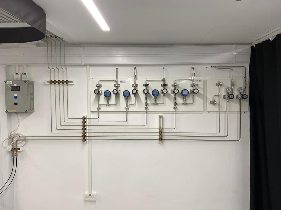 Clean-room wall with a stainless header and point-of-use valves