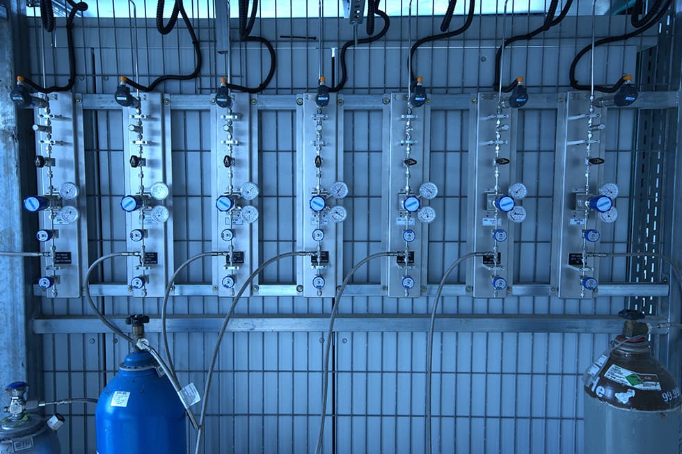 Gas cabinet interior with regulators and a cylinder