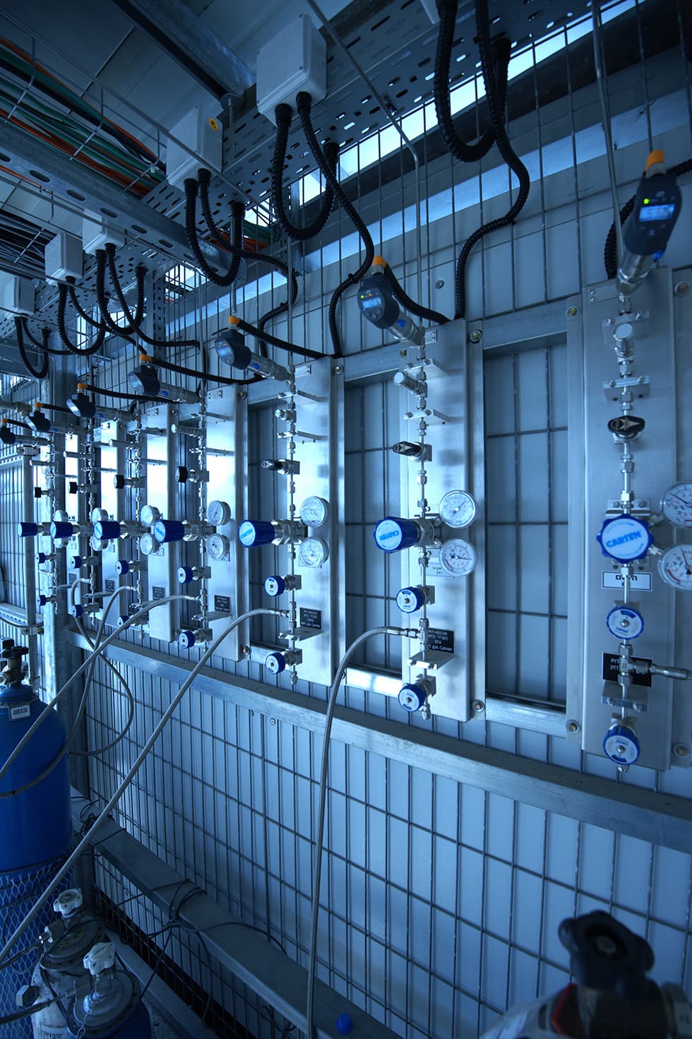 Tiled gas-room wall with regulators and pressure gauges